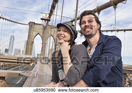 Stock Image - Happy couple on Brooklyn Bridge . Fotosearch