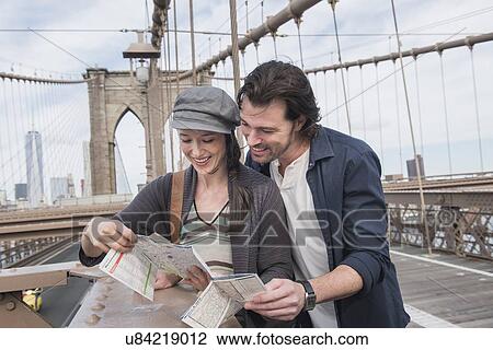 Happy couple reading map on Brooklyn Bridge View Large Photo Image Stock Image - Happy couple reading map on Brooklyn Bridge . Fotosearch