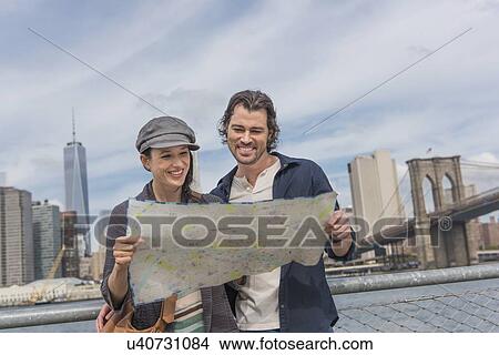 Picture - Happy couple reading map. Fotosearch