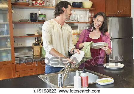 Happy couple washing dishes View Large Photo Image Stock Image - Happy couple washing dishes. Fotosearch