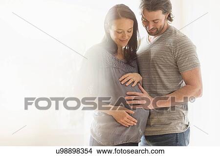 Picture - Happy man and his pregnant woman. Fotosearch