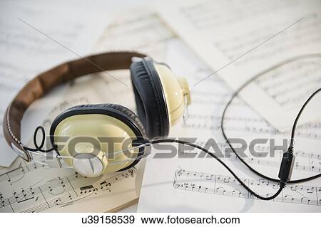 Headphones and music sheets View Large Photo Image Stock Photo - Headphones and music sheets. Fotosearch