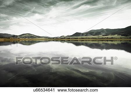 Landscape with mountain range and calm lake View Large Photo Image Stock Image - Landscape with mountain range and calm lake. Fotosearch