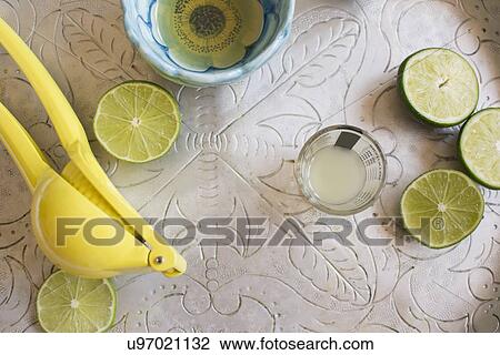 Limes and shot glass on table View Large Photo Image Stock Image - Limes and shot glass on table. Fotosearch
