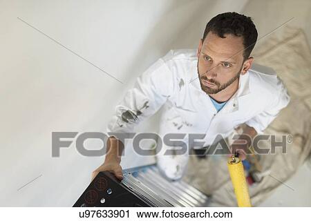 Man climbing ladder with paint roller View Large Photo Image Stock Image - Man climbing ladder with paint roller. Fotosearch