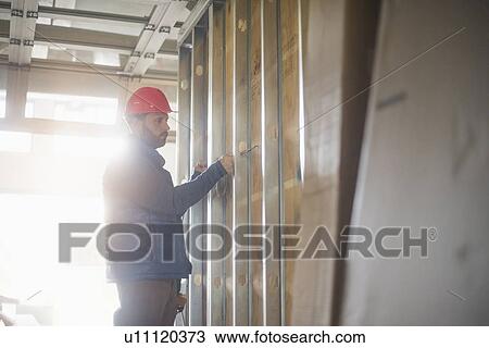 Man working at construction site View Large Photo Image Stock Image - Man working at construction site. Fotosearch