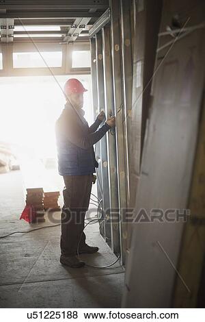 Man working at construction site View Large Photo Image Stock Photo - Man working at construction site. Fotosearch