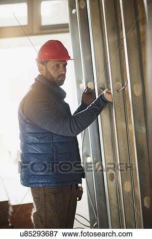 Man working at construction site View Large Photo Image Stock Photo - Man working at construction site. Fotosearch