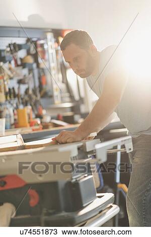 Stock Image - Man working in workshop. Fotosearch