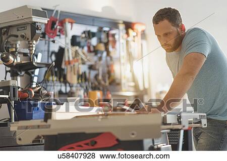 Man working in workshop View Large Photo Image Stock Photo - Man working in workshop. Fotosearch