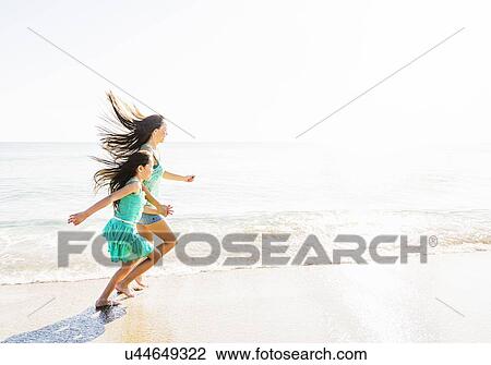 Mom and daughter (6-7) spending time together on beach View Large Photo Image Stock Image - Mom and daughter (6-7) spending time together on beach. Fotosearch