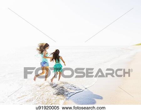 Mom and daughter (6-7) spending time together on beach View Large Photo Image Stock Photography - Mom and daughter (6-7) spending time together on beach. Fotosearch