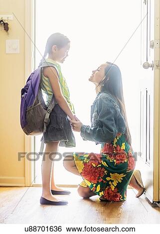 Mom and her daughter (6-7) on goodbye at front door View Large Photo Image Stock Photograph - Mom and her daughter (6-7) on goodbye at front door. Fotosearch