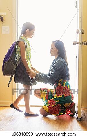Mom holding hands with her daughter (6-7) at front door View Large Photo Image Stock Photo - Mom holding hands with her daughter (6-7) at front door. Fotosearch