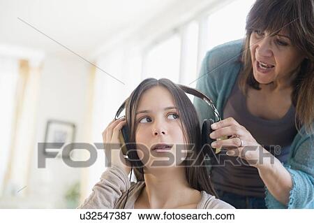Stock Photo - Mom yelling at teenage daughter (14-15). Fotosearch