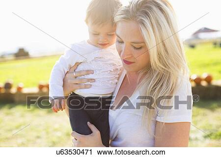 Mother and daughter (12-17 months) in pumpkin patch View Large Photo Image Stock Image - Mother and daughter (12-17 months) in pumpkin patch. Fotosearch
