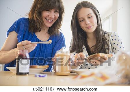 Mother and daughter (14-15) making peanut butter and jelly sandwiches View Large Photo Image Stock Photo - Mother and daughter (14-15) making peanut butter and jelly sandwiches. Fotosearch