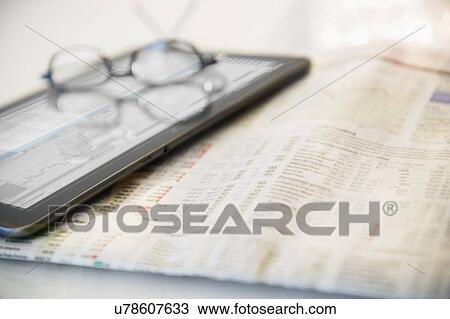 Stock Image - Newspaper, eyeglasses and digital tablet. Fotosearch