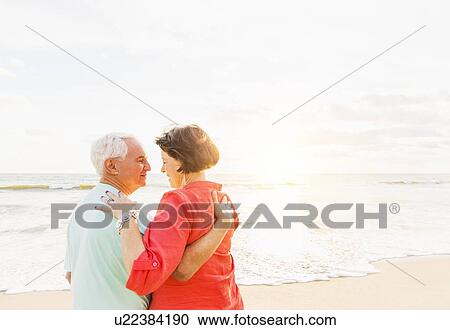 Older couple spending time together on beach View Large Photo Image Stock Image - Older couple spending time together on beach. Fotosearch