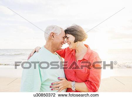 Older couple spending time together on beach View Large Photo Image Stock Image - Older couple spending time together on beach. Fotosearch