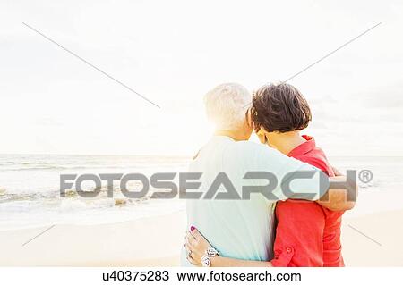 Older couple spending time together on beach View Large Photo Image Stock Image - Older couple spending time together on beach. Fotosearch