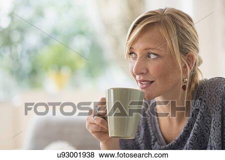 Stock Photo - Pensive woman drinking coffee. Fotosearch