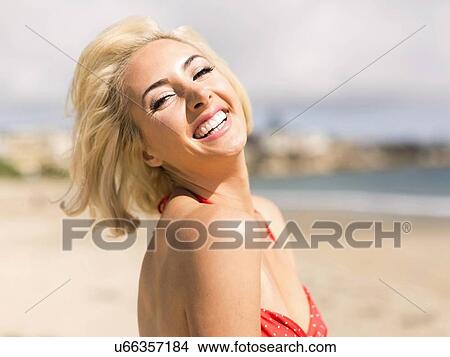 Picture - Portrait of blond woman on beach. Fotosearch