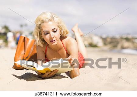 Portrait of blond woman reading book on beach View Large Photo Image Stock Image - Portrait of blond woman reading book on beach. Fotosearch