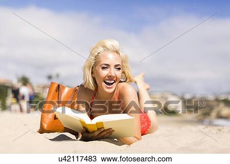 Portrait of blond woman reading book on beach View Large Photo Image Stock Image - Portrait of blond woman reading book on beach. Fotosearch