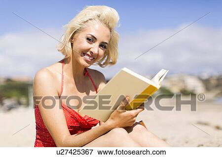 Portrait of blond woman reading book on beach View Large Photo Image Stock Photo - Portrait of blond woman reading book on beach. Fotosearch