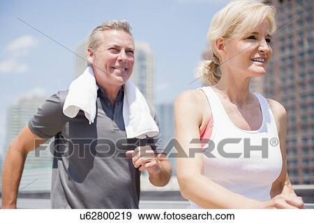 Portrait of couple jogging in city View Large Photo Image Stock Photo - Portrait of couple jogging in city. Fotosearch