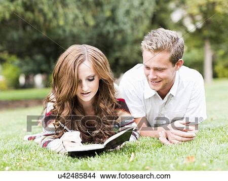 Portrait of couple laying in grass View Large Photo Image Picture - Portrait of couple laying in grass. Fotosearch