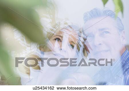 Portrait of couple looking out of window View Large Photo Image Stock Image - Portrait of couple looking out of window. Fotosearch