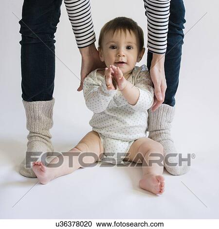 Stock Image - Portrait of cute baby girl (12-17 months) with her mom. Fotosearch