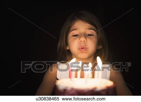 Portrait of girl (6-7) blowing out birthday candles View Large Photo Image Stock Photography - Portrait of girl (6-7) blowing out birthday candles . Fotosearch