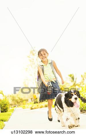 Portrait of girl (6-7) walking her dog View Large Photo Image Stock Photo - Portrait of girl (6-7) walking her dog. Fotosearch