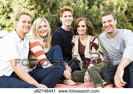 Portrait of group of friends in park View Large Photo Image Stock Image - Portrait of group of friends in park. Fotosearch