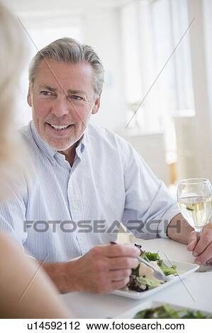 Portrait of man eating and drinking white wine at restaurant View Large Photo Image Stock Image - Portrait of man eating and drinking white wine at restaurant. Fotosearch