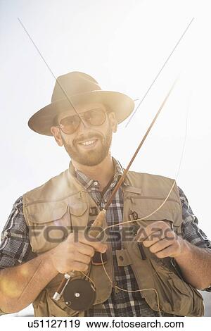 Portrait of man holding fishing rod View Large Photo Image Stock Photo - Portrait of man holding fishing rod. Fotosearch