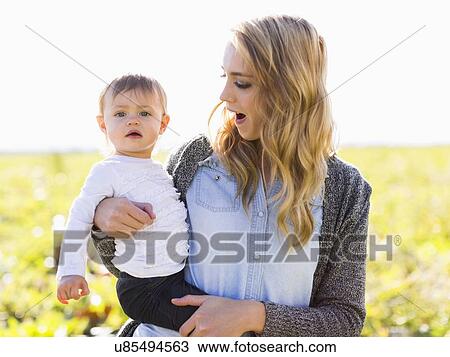 Stock Image - Portrait of mother and daughter (12-17 months). Fotosearch