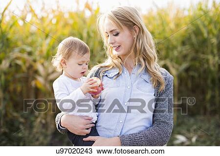 Portrait of mother and daughter (12-17 months) in field View Large Photo Image Stock Image - Portrait of mother and daughter (12-17 months) in field. Fotosearch