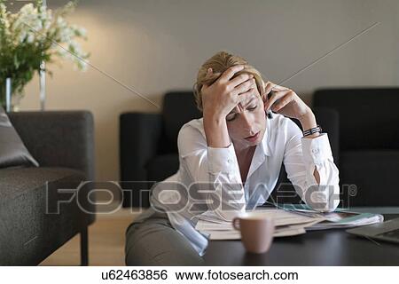 Stock Photograph - Portrait of sad woman using mobile phone. Fotosearch