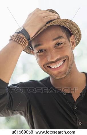 Portrait of smiling man in straw hat View Large Photo Image Stock Photo - Portrait of smiling man in straw hat. Fotosearch