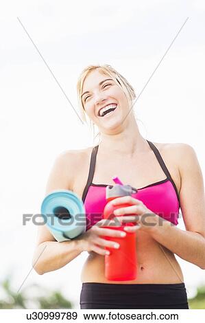 Portrait of smiling woman drinking water View Large Photo Image Stock Photo - Portrait of smiling woman drinking water. Fotosearch