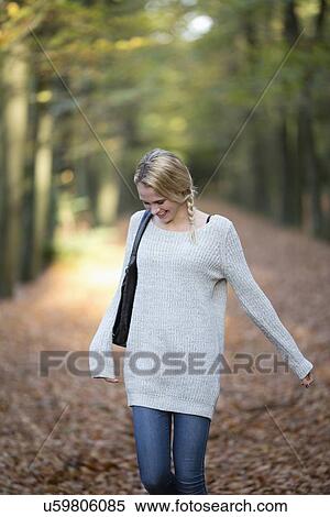 Stock Photography - Portrait of smiling woman in autumn forest. Fotosearch