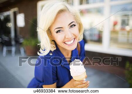 Portrait of smiling woman with ice-cream View Large Photo Image Picture - Portrait of smiling woman with ice-cream. Fotosearch