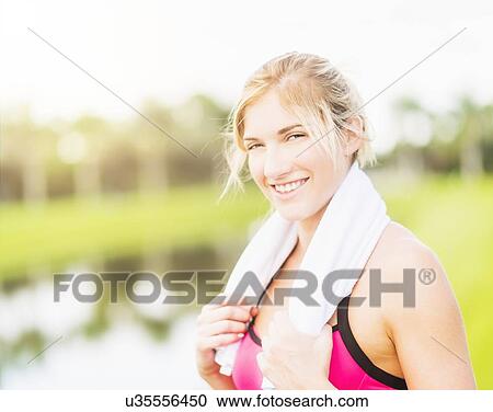 Portrait of smiling woman with towel around neck View Large Photo Image Stock Image - Portrait of smiling woman with towel around neck. Fotosearch
