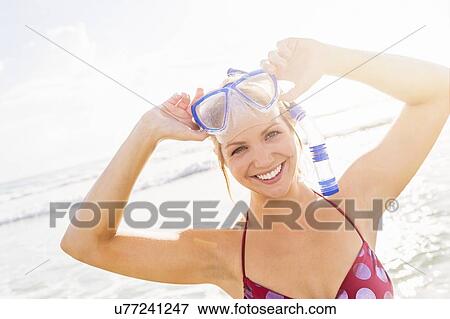 Stock Photo - Portrait of smiling young woman wearing scuba mask and snorkel. Fotosearch