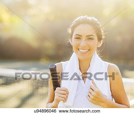 Portrait of smiling young woman with towel and tennis racket View Large Photo Image Stock Photograph - Portrait of smiling young woman with towel and tennis racket. Fotosearch