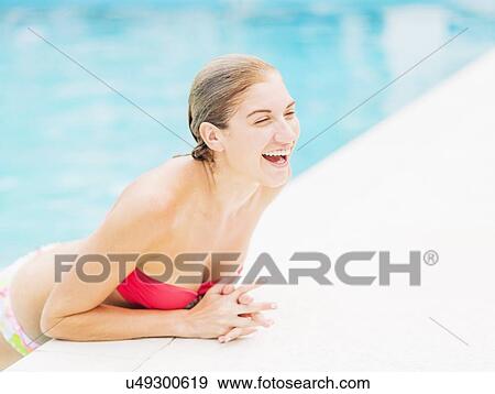 Portrait of woman on edge of swimming pool View Large Photo Image Stock Photo - Portrait of woman on edge of swimming pool. Fotosearch